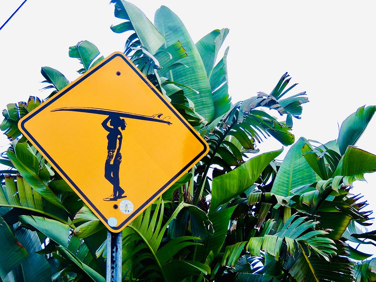 surfer girl crossing sign near beach in Encinitas